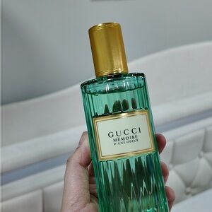 Gucci green and gold perfume bottle
